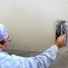 Apply smoothing or concrete filler on wall